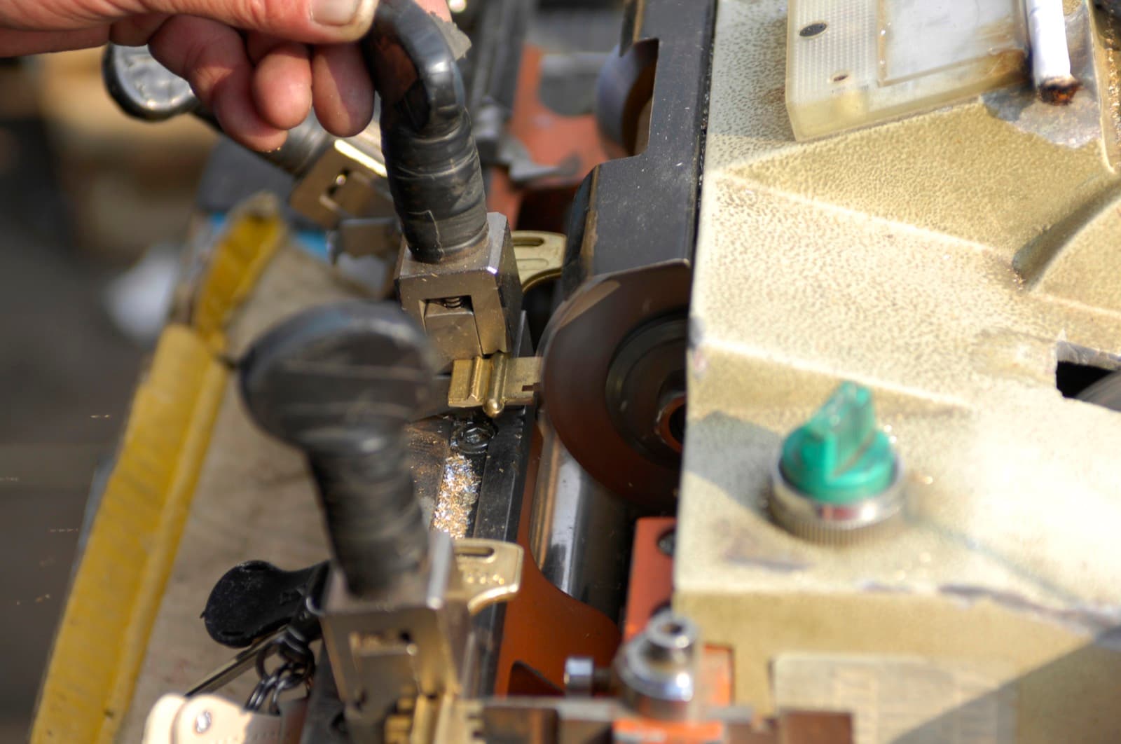 A key being cut on a key duplicating machine
